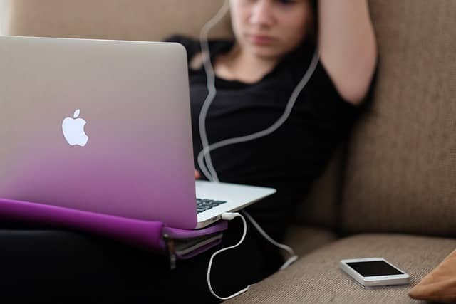 A Girl, macbook and apple phone